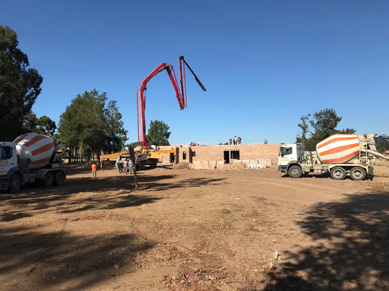 Concrete pump and ready-mix trucks on site for the slab pour