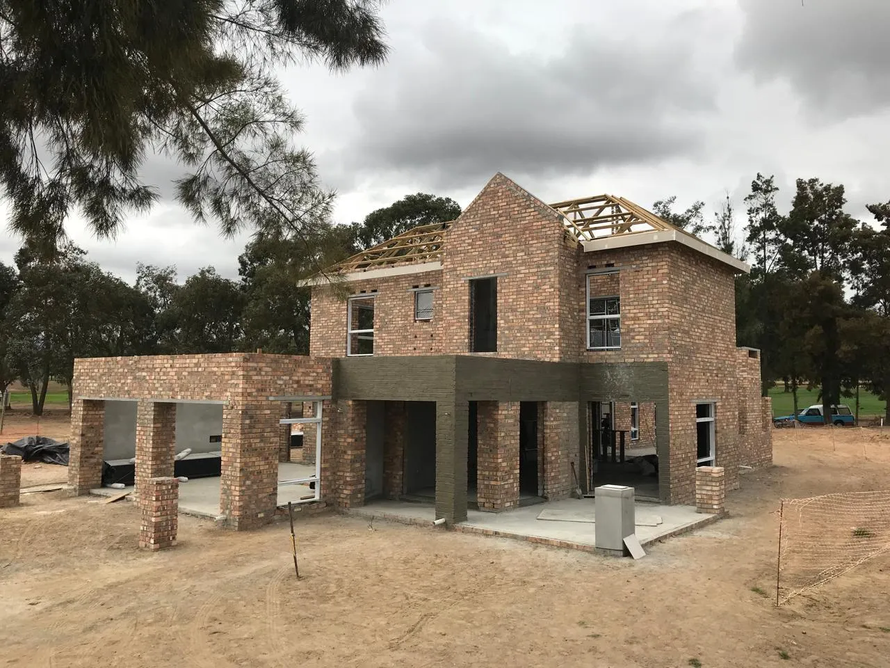 Face-brick facade with steel window frames and a covered patio